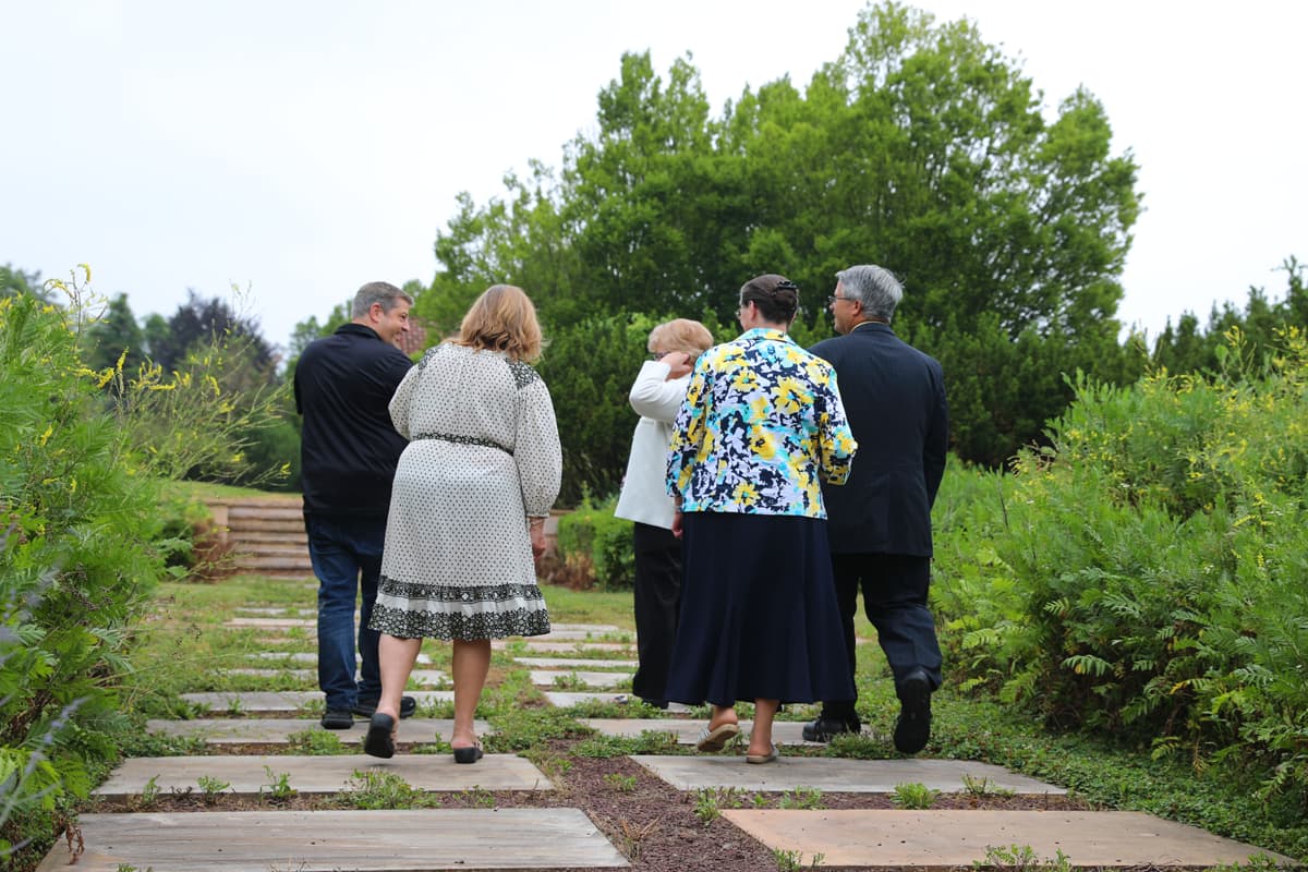 Donors walking through the Agape Gardens at Servant’s Oasis Donors walking through the Agape Gardens at Servant's Oasis.